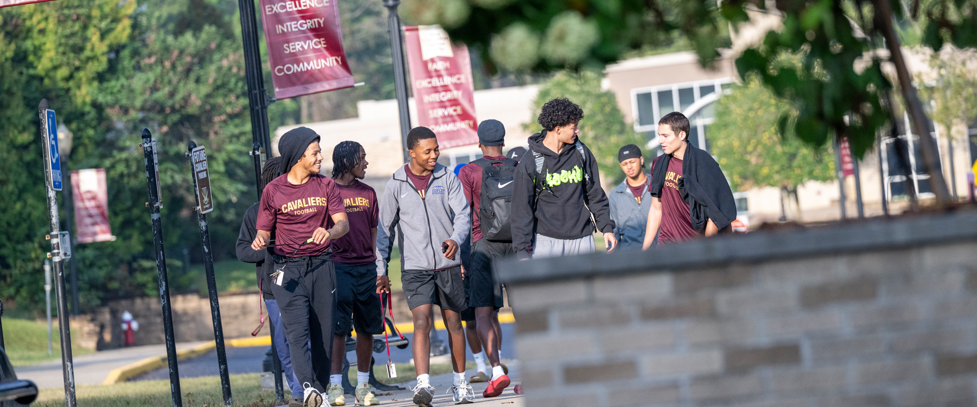 Walsh University students walking and talking together.