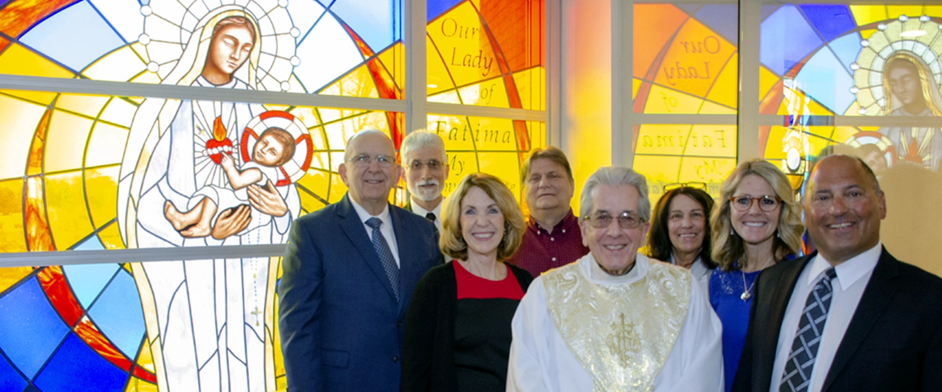 group photo of President Jusseaume and donors at the Our Lady of Fatima window Dedication