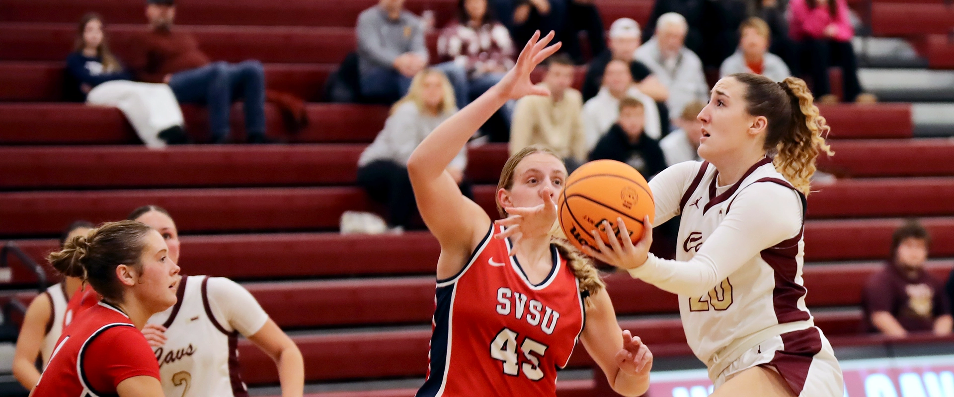 photo of a Walsh women's basketball player driving to the basket