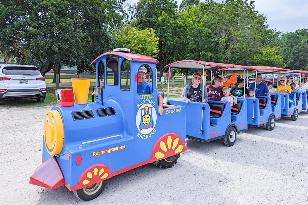 A blue train provides rides at the Hoover Park Festival. 