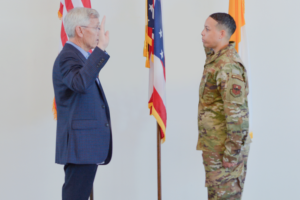 President Collins swears in with a member of the military
