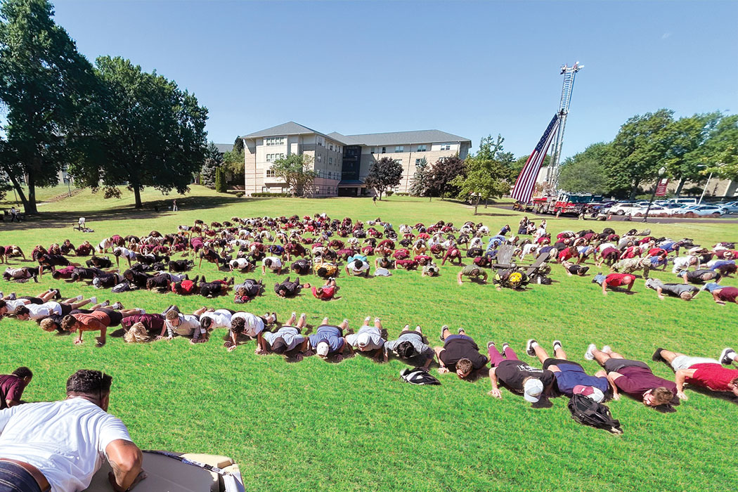 Photo of Push-Ups event from 2025. Students on Walsh Campus doing push-ups. 