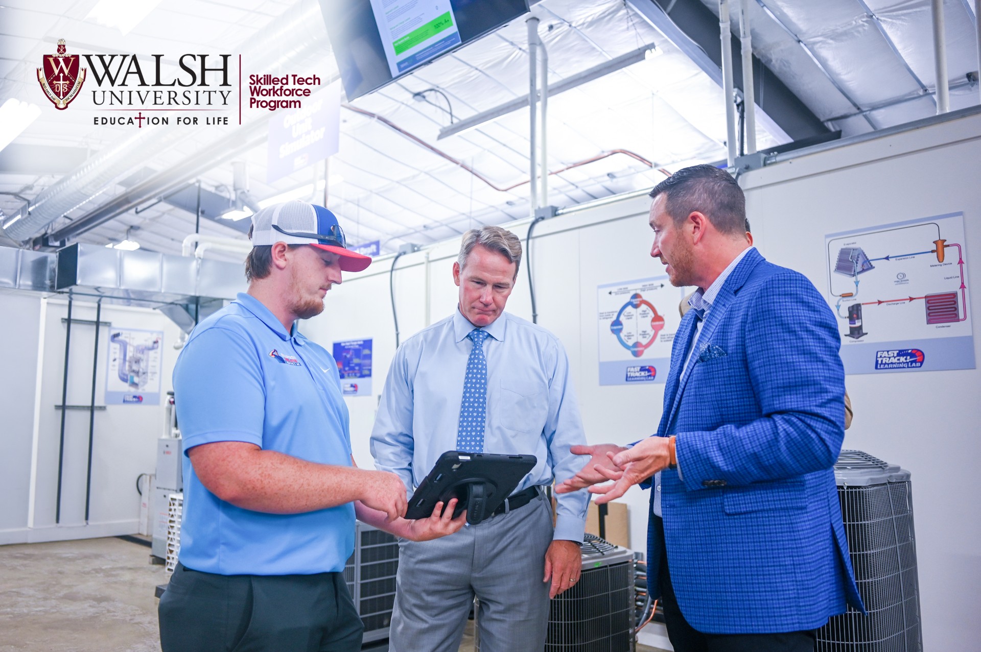 Senator Jon Husted is shown information on a tablet within the Fast Track Learning Lab. 