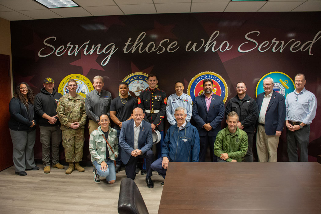 Group photo of attendees at the military veteran lounge opening