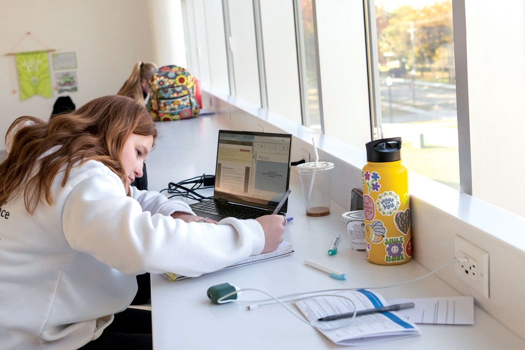 photo of a student studying near a window